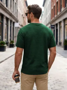 Back view of men's dark green waffle knit short sleeve t-shirt in street setting