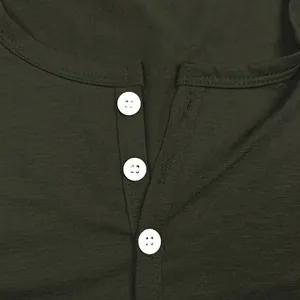 Close-up showing the three-button placket and slub cotton texture of a men's Henley shirt
