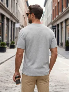 Detailed back view of men's grey waffle knit short sleeve Henley shirt on a street