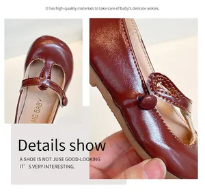 Close-up of girls' brown leather Mary Jane shoes showing stitching and soft material.