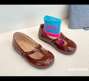 Close-up of burgundy kids' Mary Jane shoes with soft leather and T-strap design.
