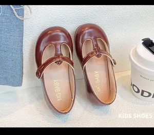 Detailed view of brown T-strap Mary Jane princess shoes for girls with glossy finish
