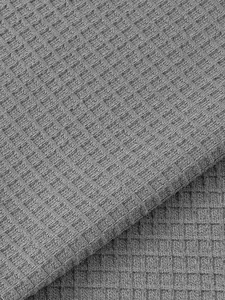 Close-up detail of gray waffle knit fabric texture for men's Henley shirt