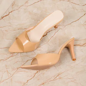 Detailed side view of nude patent leather high-heel mules with elegant stiletto heels.