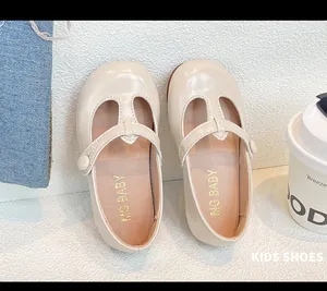 Top view detail of beige T-strap girls' Mary Janes with soft inner lining.
