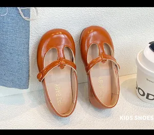 Close-up top view of brown girls' T-strap Mary Jane leather shoes with soft soles