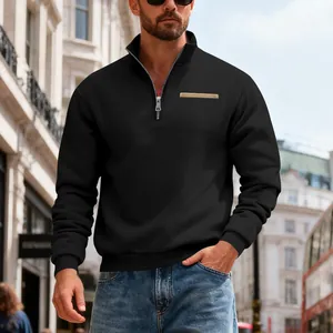 View of men's black heavyweight sweatshirt with half-zip detail in an urban street setting