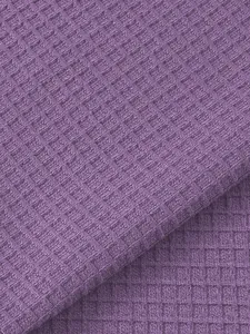Macro detail view of the high-quality purple waffle knit fabric for men's Henley shirt