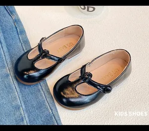 Detailed view of black patent leather Mary Jane shoes for girls with elegant T-strap