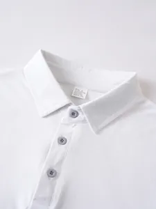 Close-up detail of a white men's polo shirt collar featuring the fabric composition tag