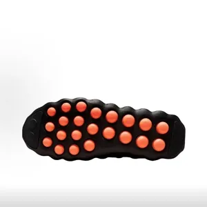 Detail view of high-performance black training shoe sole with orange massage pods