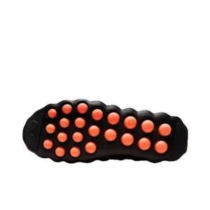 Mind 002 training shoe sole with orange massage nodes and black rubber