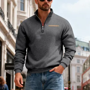 Close-up of a men's heavyweight half-zip grey fleece sweatshirt in a city setting.