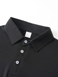 Close-up detail of black polo shirt collar showing buttons and fabric texture