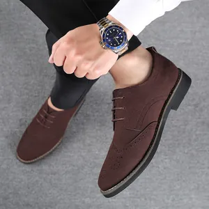 Macro view of men's dark brown suede wingtip brogue shoes featuring classic lace-up design