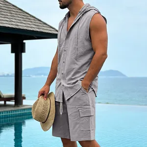 Detail view of grey linen sleeveless hooded shirt and cargo shorts on a beach resort
