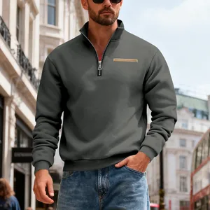 Casual men's charcoal grey half-zip heavyweight pullover sweatshirt in urban street setting.