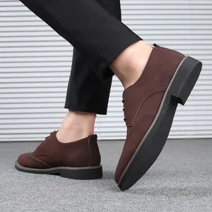 Detailed view of men's brown suede Brogue shoes with elegant wingtip perforation