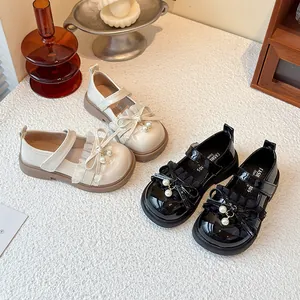 Elegant girls Mary Jane shoes with pearls and bows, soft sole black and cream leather shoes.