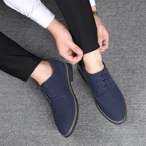 Close-up of men's blue suede Brogue shoes featuring classic wingtip perforated details.