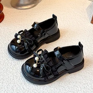 Elegant girls black patent leather Mary Jane shoes with bow and luxury pearl details