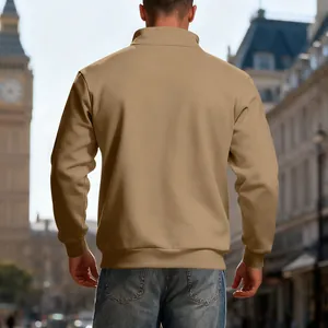 Back view of a khaki heavyweight half-zip sweatshirt in a city street setting