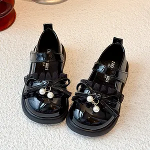 Elegant girls black patent leather Mary Jane shoes featuring a cute bow and pearl charms