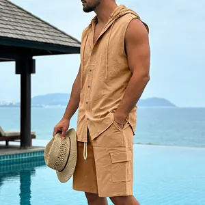 Model wearing a khaki sleeveless hooded linen shirt and cargo shorts at a beach resort