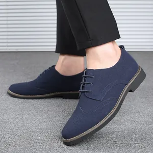 Detailed side view of navy blue suede Brogue shoes for men with intricate wingtip patterns