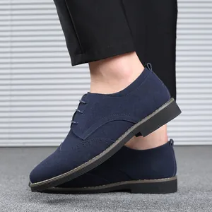 Close-up detail of navy blue suede men's Brogue shoes with elegant wingtip patterns