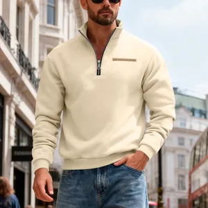 Close-up of men's beige heavyweight half-zip sweatshirt in a stylish urban street setting