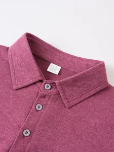 Close-up detail of a pink polo shirt collar showing fabric texture and gray buttons.