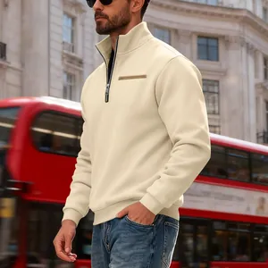 Detail view of a men's heavy cream half-zip fleece sweatshirt in a city street setting