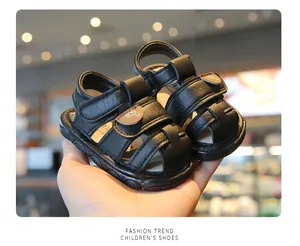 Detailed view of black toddler sandals with non-slip sole and cute bear strap detail