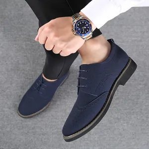 Detailed view of stylish men's navy blue suede Brogue shoes with classic wingtip design