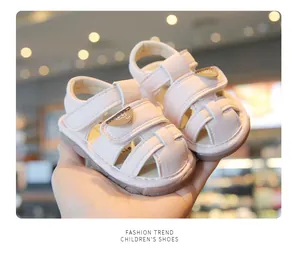 Detailed close-up of pink baby toddler sandals with soft sole and cute bear pattern strap
