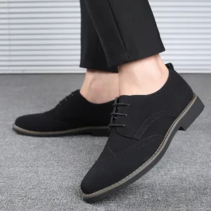 Close-up of men's black suede Brogue dress shoes with classic wingtip design and laces