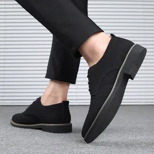 Close-up detail of black suede Brogue casual shoes with traditional lace-up design.