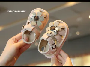 Detailed view of pink baby sandals with soft soles and decorative flower