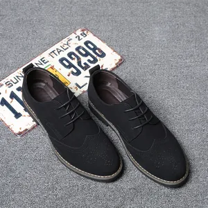Top-down view of men's black suede Brogue shoes featuring classic wingtip detailing