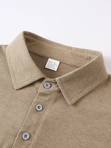 Close-up detail of men's polo shirt collar with fabric tag showing material blend