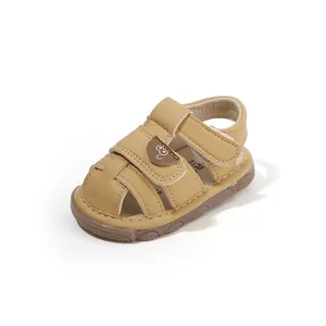 Comfortable tan soft-sole baby sandals with closed-toe design and cute cartoon strap