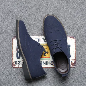 Close-up of blue suede Brogue shoes with intricate perforated detailing and laces