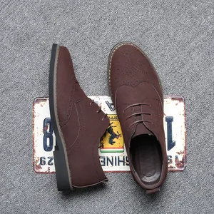 Close-up view of brown suede Brogue shoes with classic wingtip detailing on carpet.