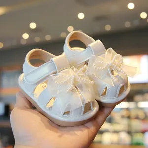 Elegant white baby girl sandals with lace bow and pearl details for summer