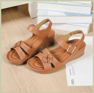 Detailed view of stylish brown women's wedge sandals with floral accents and cut-outs