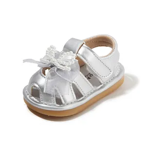 Baby girl's silver closed-toe sandals featuring pearl bow and soft anti-slip rubber sole