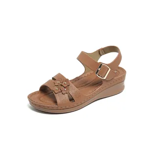 Elegant brown wedge sandals for women featuring floral details and a gold buckle strap