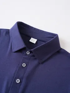 Detailed macro shot of navy blue polo shirt collar with buttons and care label info