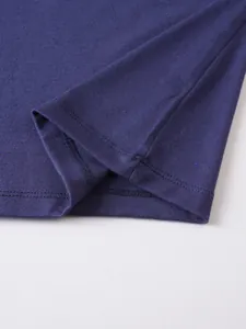 Close-up detail showing professional double-stitching on navy blue polo shirt hem and seam